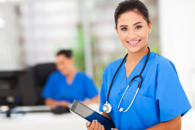 nurse holding tablet and smiling